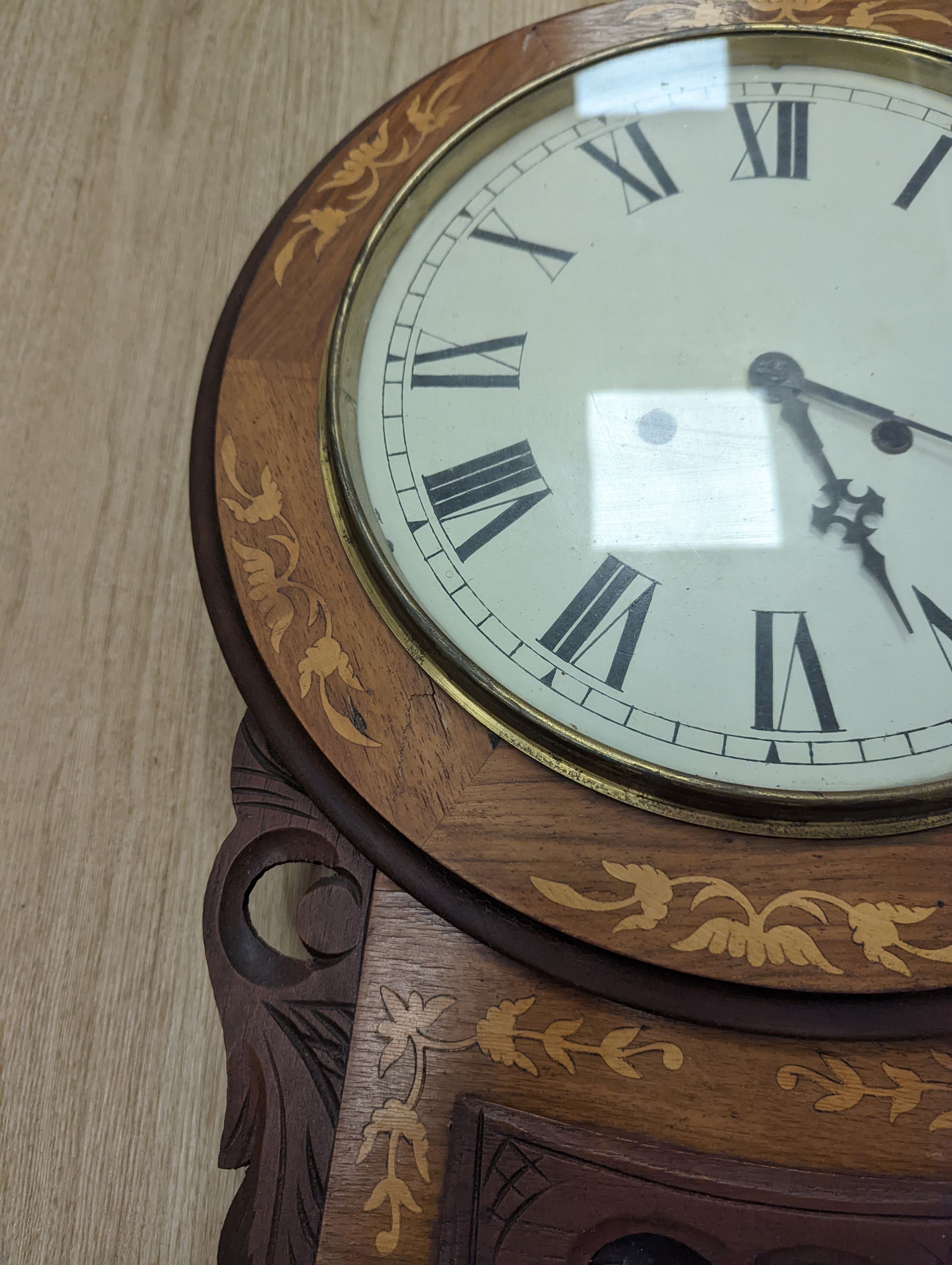 An American marquetry drop dial wall clock, 27cm enamelled dial, with key and pendulum